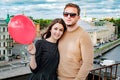 The newly married couple on the roof of house in red sunset with bubbles Royalty Free Stock Photo