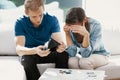 Married couple sitting at home looking at their finance problems Royalty Free Stock Photo