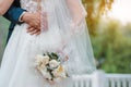 Newly married couple. Wedding day. Bouquet of the bride in the hands, the groom's embrace Royalty Free Stock Photo