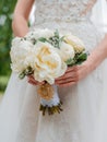 Newly married couple. Wedding day. Bouquet of the bride in the hands, the groom's embrace Royalty Free Stock Photo