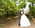 Newly married couple. Wind lifting long white bridal veil Royalty Free Stock Photo