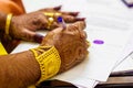 A newly married indian bengali wife with golden ornament and blacelet signing marriage registration form