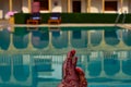 Newly married woman with henna feet in front of a swimming pool on her honeymoon in a resort in Jaisalmer, India Royalty Free Stock Photo