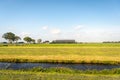 Newly mowed grassland in the foreground with a modern farm with Royalty Free Stock Photo