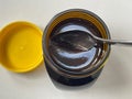 Newly opened yeast extract marmite jar with spoon