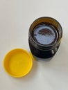 Newly opened yeast extract marmite jar on white background from above