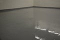 Newly painted garage floor with gray latex paint. the surface is glossy and easy to maintain and wash. resistant to oil and chemic