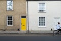 Newly painted yellow door of a terraced house seen in central London.