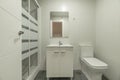 Newly renovated bathroom with a square frameless mirror, a porcelain