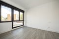 Newly renovated empty room with large black aluminum window