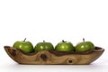 Newly washed green apples in olive wood bowl