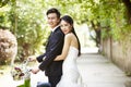 Asian wedding couple riding bicycle Royalty Free Stock Photo