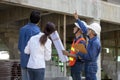 Newly wed couple is meeting with engineering contractor at their under construction house to inspect the building progress and Royalty Free Stock Photo