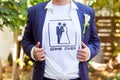 Newlywed in blue costume with opened shirt showing t-shirt with