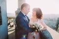 Newlywed bride and groom embracing on the balcony of old gothic cathedral Royalty Free Stock Photo