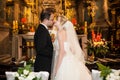 Newlywed bride and groom first kiss at wedding ceremony in church Royalty Free Stock Photo