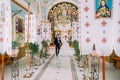 Newlywed bride and groom walking out of church holding hands Royalty Free Stock Photo