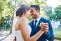 Newlywed couple dancing outside. Mixed race bride and groom enjoying romantic moments on their wedding day. Happy young Royalty Free Stock Photo