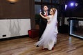 Newlywed couple first dance at ballroom, bride and groom dancing