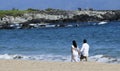 A Newlywed Couple Hold Hands Walking DT Fleming Beach Park, West Royalty Free Stock Photo
