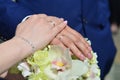 The newlywed couple is holding a beautiful wedding bouquet. Classical wedding photography, symbolizing unity, love and the creati