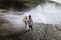 Newlywed couple on lava cliffs