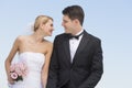 Newlywed Couple Looking At Each Other Against Clear Blue Sky Royalty Free Stock Photo