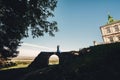 Newlywed couple posing near old castle wall, fairytale wedding at ancient castle outdoors, bride and groom hugging near fortress Royalty Free Stock Photo