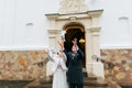 Newlywed couple releasing doves to fly when leaving church after their wedding ceremony Royalty Free Stock Photo