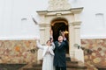 Newlywed couple releasing white doves when leaving church after their wedding ceremony Royalty Free Stock Photo