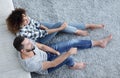 Newlywed couple sitting on a carpet in a new living room Royalty Free Stock Photo