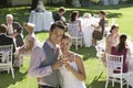 Newlywed Couple Toasting Champagne In Garden