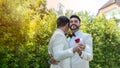 Newlywed gay couple holding hands and dancing on wedding day celebration Royalty Free Stock Photo