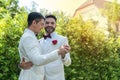 Newlywed gay couple holding hands and dancing on wedding day celebration Royalty Free Stock Photo