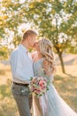 Newlywed`s kiss on wedding, the bride and groom sincerely show their feelings, the girl with the blond hairstyle in a Royalty Free Stock Photo