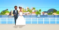 Newlyweds african american couple standing together bride and groom embracing wedding day concept mountain city island