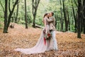 Newlyweds in an autumn romantic forest. Wedding ceremony outdoors. Royalty Free Stock Photo