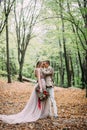 Newlyweds in an autumn romantic forest. Wedding ceremony outdoors. Royalty Free Stock Photo