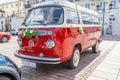 Newlyweds car. Red minibus volkswagen. Retro bus car. Decorated with bouquets of flowers. Festive decor, bridal bouquet Royalty Free Stock Photo