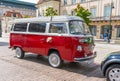 Newlyweds car. Red minibus volkswagen. Retro bus car. Decorated with bouquets of flowers. Festive decor, bridal bouquet