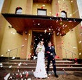 Newlyweds coming out of the church after wedding ceremony Royalty Free Stock Photo