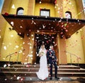 Newlyweds coming out of the church after wedding ceremony. Royalty Free Stock Photo