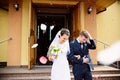 Newlyweds coming out of the church after wedding ceremony. Royalty Free Stock Photo