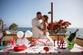 Newlyweds couple kisses in front of the wedding cake, passionate moment