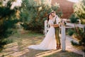 Stylish romantic couple standing and hugging on ranch