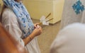 newlyweds in embroidered clothes hold lighted candle in church. wedding. close up.