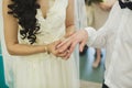Newlyweds exchange rings, groom puts the ring on the bride`s hand in marriage registry office. Royalty Free Stock Photo