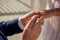 Newlyweds exchange rings, groom puts the ring on the bride& x27;s hand. Royalty Free Stock Photo