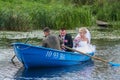 Newlyweds floating by boat. People on the lake.