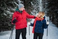 Newlyweds go skiing on a cool winter day in the woods and give each other support